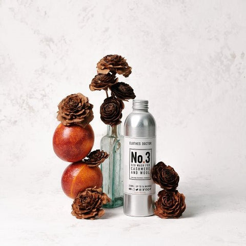 Bottle of detergent surrounded by brown flowers